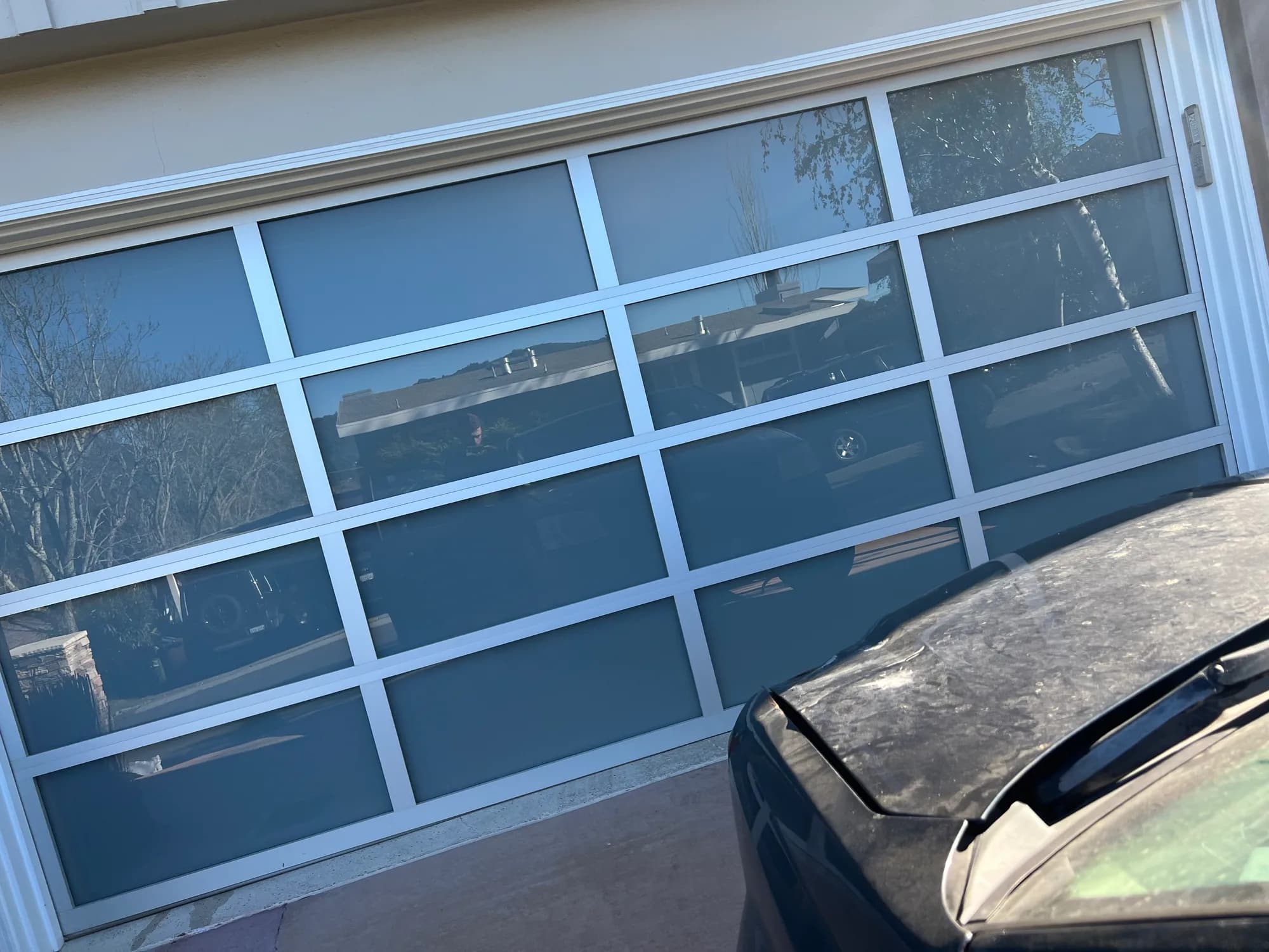 Black-frame full-view glass garage door