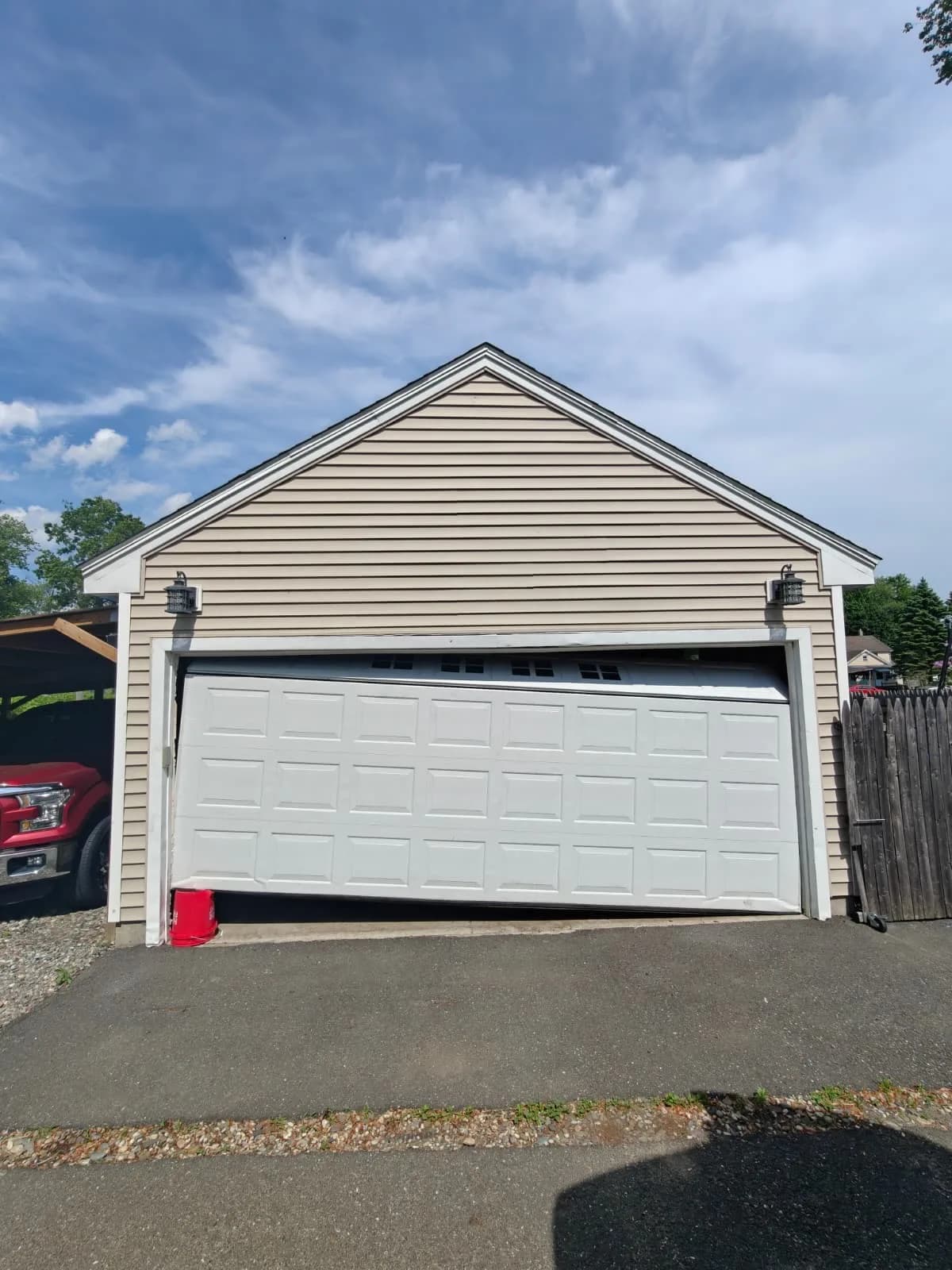Garage door hanging crooked after coming off the track