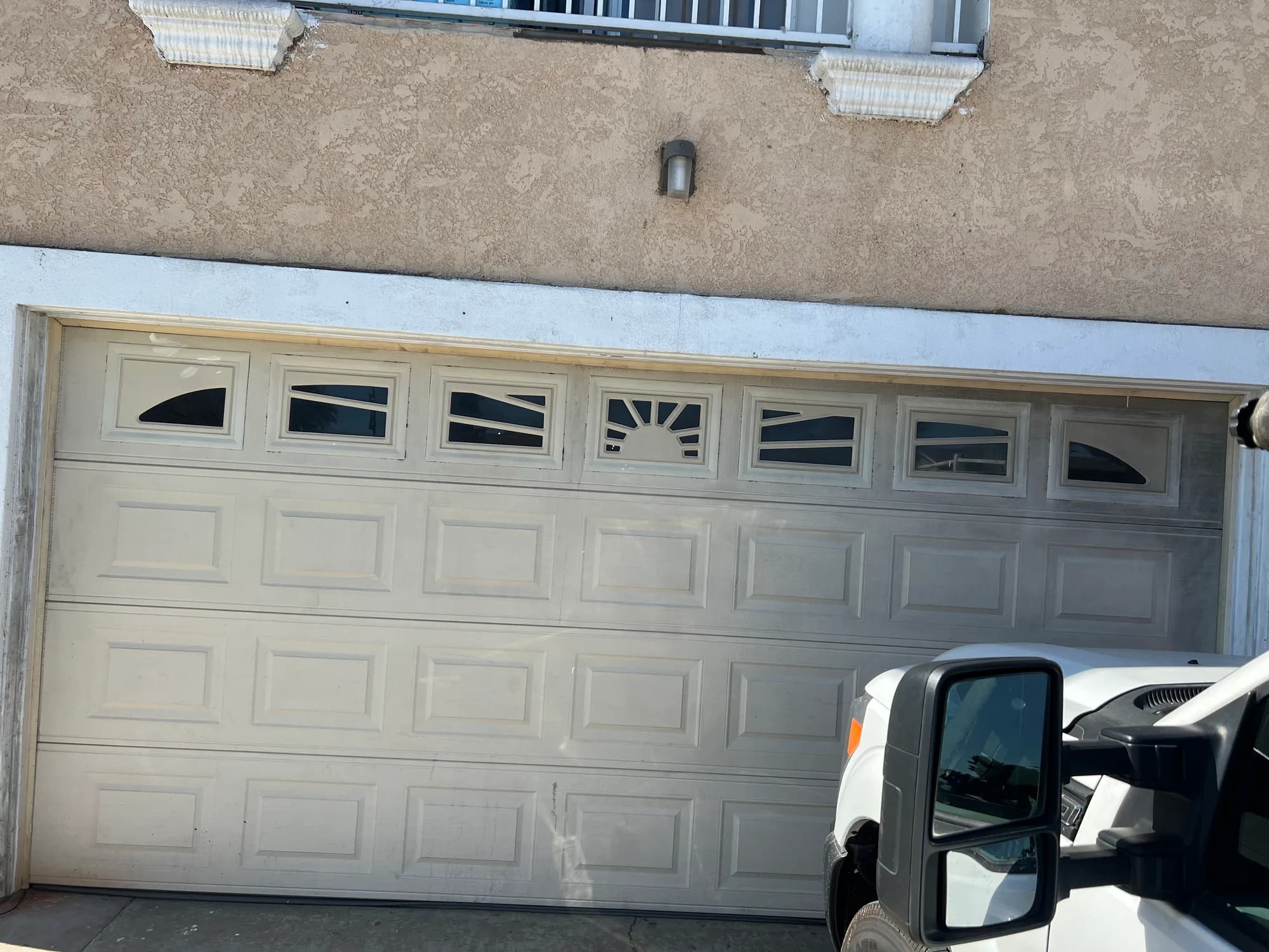 White garage door with sunburst windows