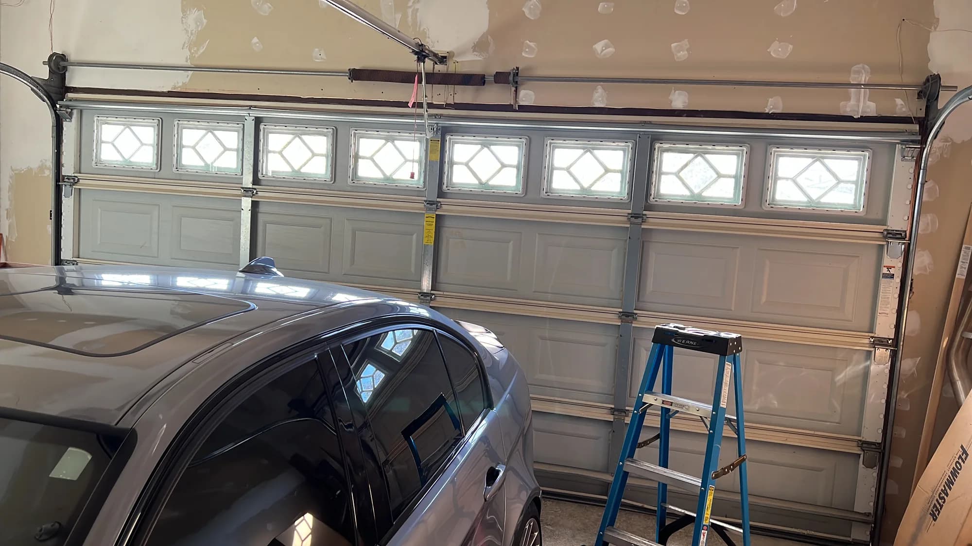 White garage door with windows from inside the garage