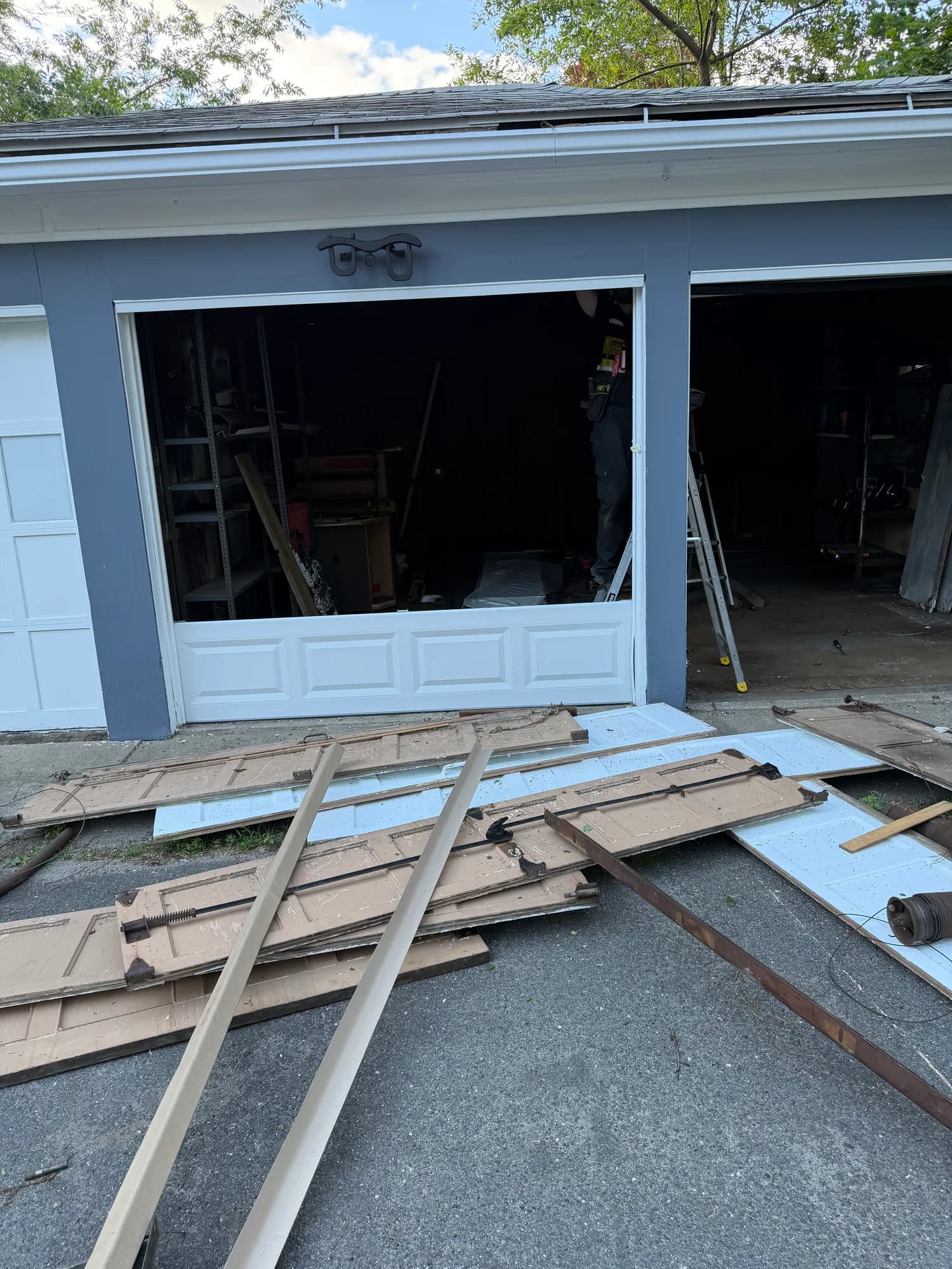 Garage door replacement in progress on a driveway