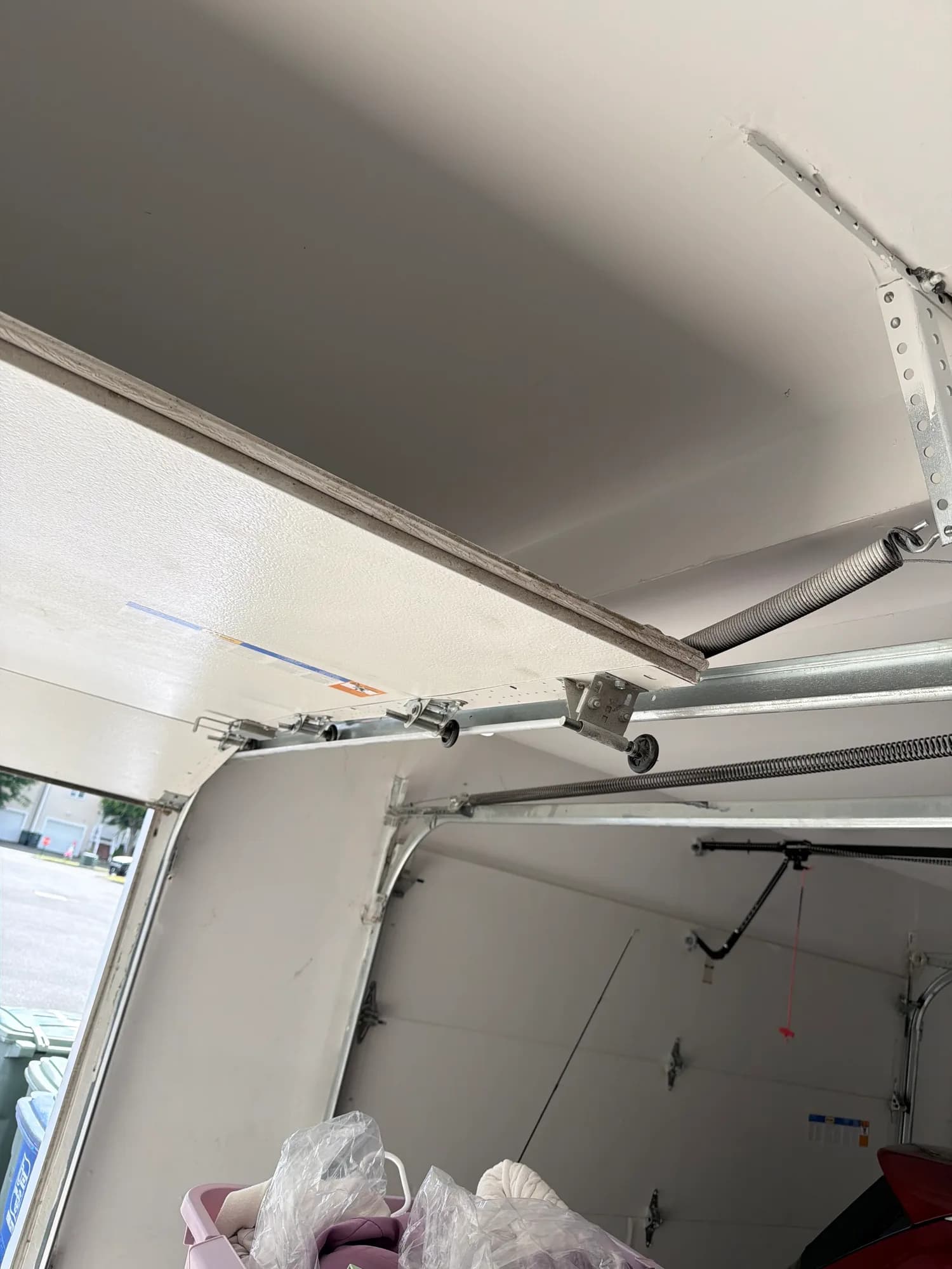 White garage door vertical track after roller service