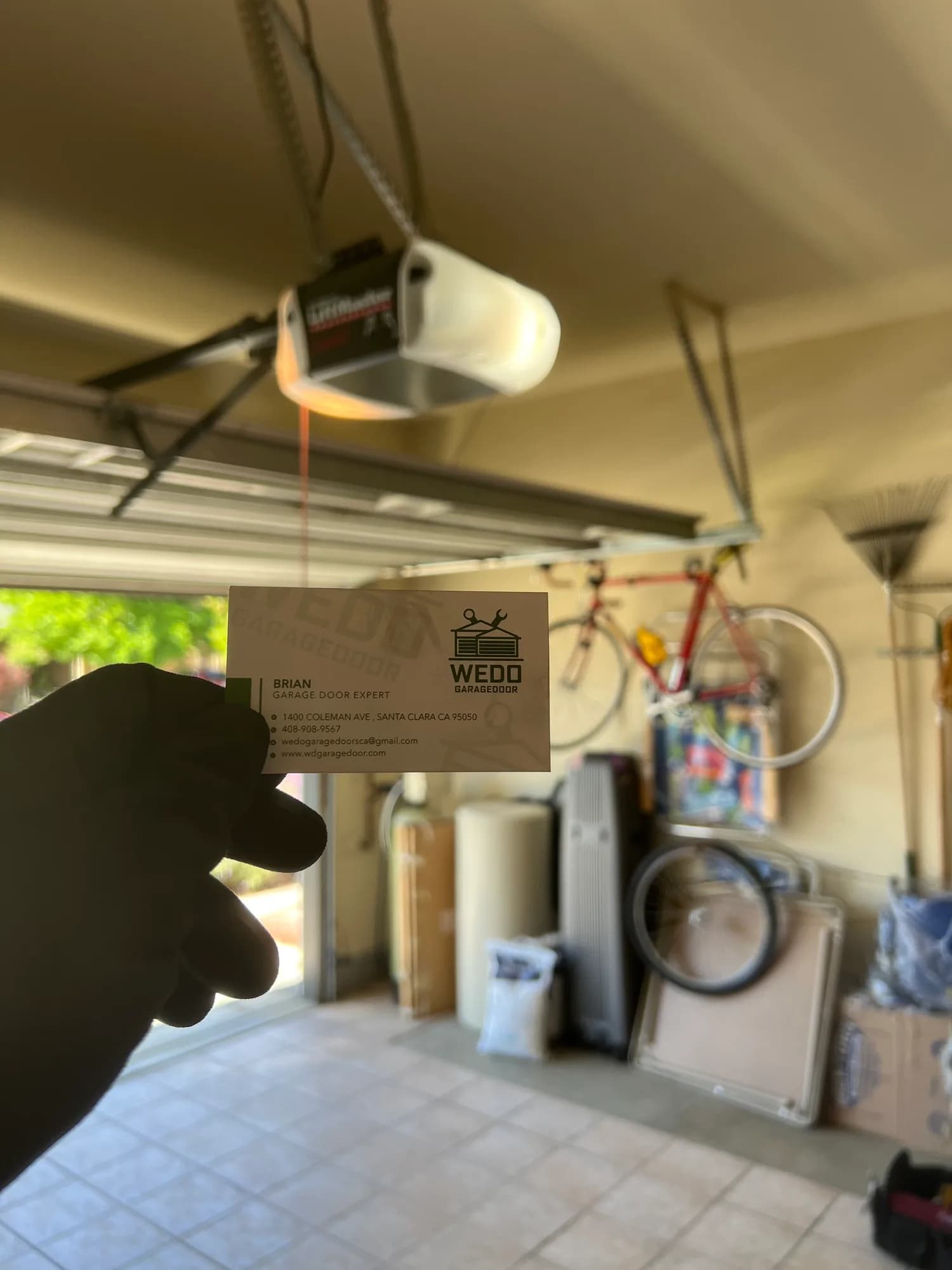 Technician servicing a ceiling-mounted garage door opener