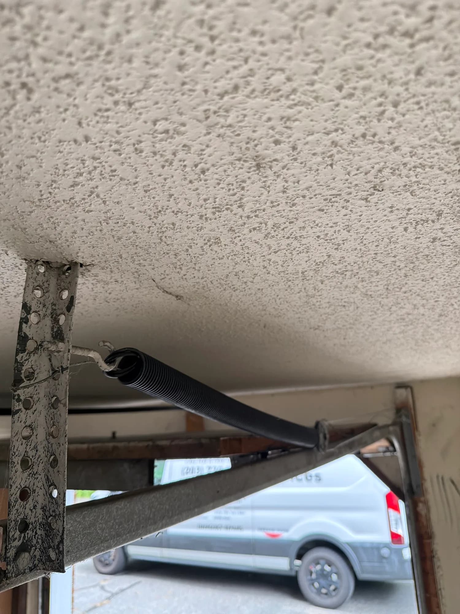 Close-up of a garage door roller in the track